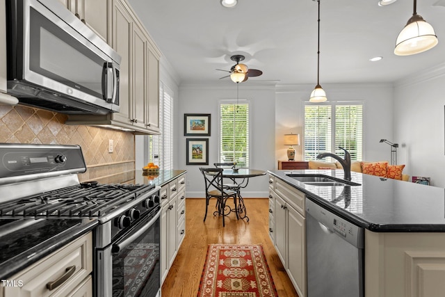 145 Cofield Cir, Durham, NC 27707 - kitchen featuring stainless steel appliances, dark countertops, tasteful backsplash, light wood finished floors, and crown molding