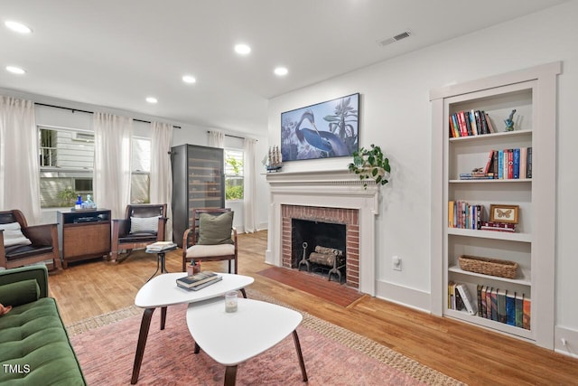 2410 Huron St, Durham, NC 27707 - living room featuring a fireplace, wood finished floors, and recessed lighting