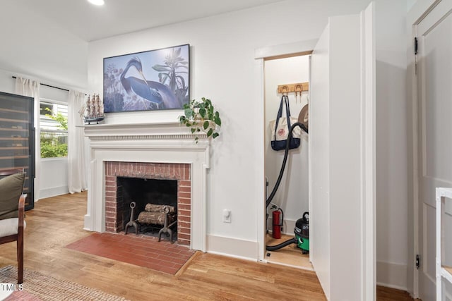 2410 Huron St, Durham, NC 27707 - living area featuring a brick fireplace, wood finished floors, and recessed lighting