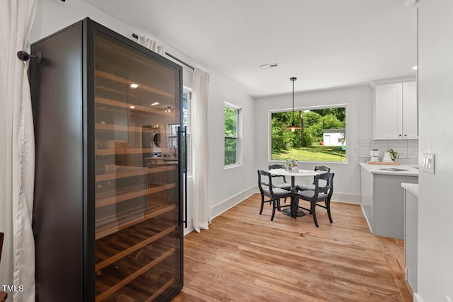 2410 Huron St, Durham, NC 27707 - dining room with wine cooler, light wood-style floors, and recessed lighting