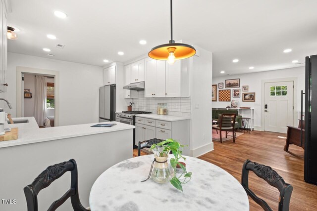 2410 Huron St, Durham, NC 27707 - dining room featuring wood finished floors and recessed lighting