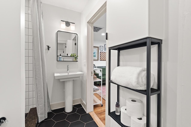 2410 Huron St, Durham, NC 27707 - full bathroom featuring tiled shower and tile patterned flooring