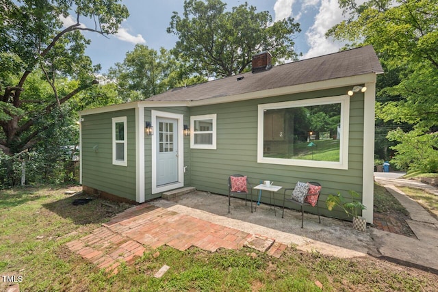2410 Huron St, Durham, NC 27707 - rear view of property featuring a patio and a chimney