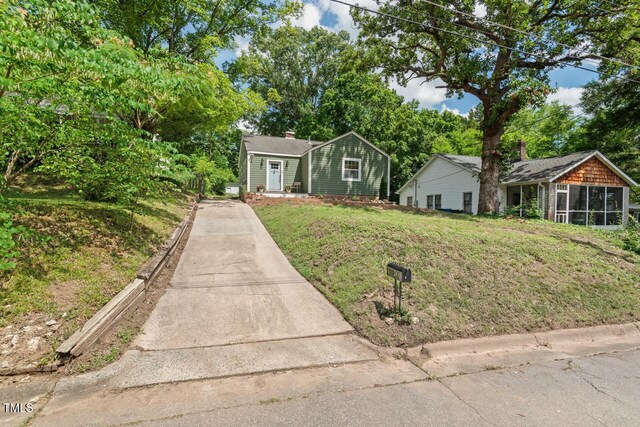 2410 Huron St, Durham, NC 27707 - view of front of house with a sunroom, driveway, and a front yard
