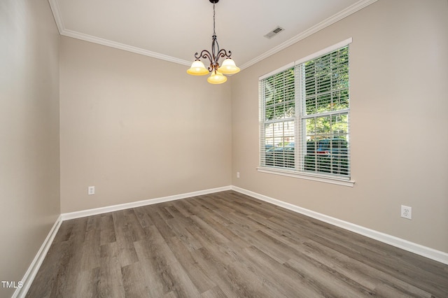 2261 Plum Frost Dr, Raleigh, NC 27603 - unfurnished room with a chandelier, wood finished floors, and ornamental molding