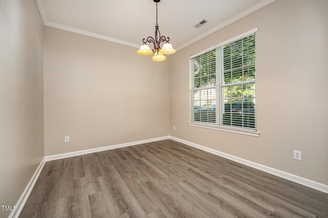 2261 Plum Frost Dr, Raleigh, NC 27603 - unfurnished room with a chandelier, wood finished floors, and ornamental molding