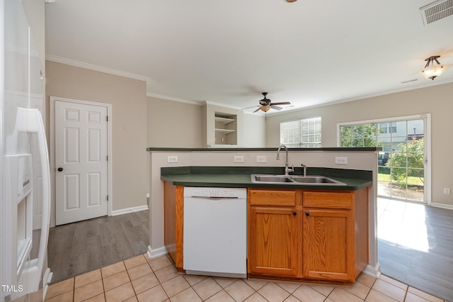 2261 Plum Frost Dr, Raleigh, NC 27603 - kitchen featuring dishwasher, dark countertops, ceiling fan, crown molding, and light tile patterned floors