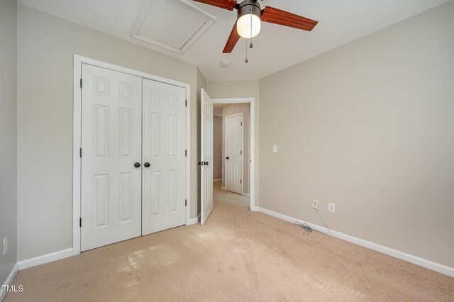 2261 Plum Frost Dr, Raleigh, NC 27603 - unfurnished bedroom featuring light colored carpet, a closet, ceiling fan, and attic access