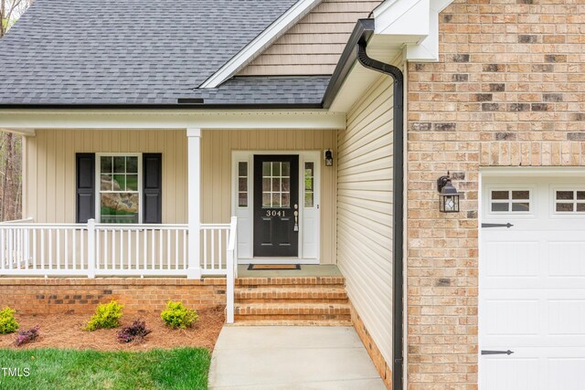 3041 Wesley Farm Ln, Sophia, NC 27350 - doorway to property featuring roof with shingles and covered porch