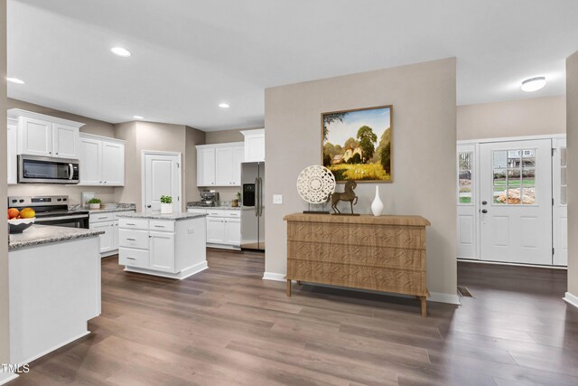 3041 Wesley Farm Ln, Sophia, NC 27350 - kitchen featuring appliances with stainless steel finishes, dark wood-type flooring, white cabinetry, a kitchen island, and recessed lighting