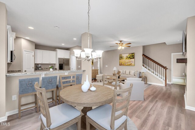 3041 Wesley Farm Ln, Sophia, NC 27350 - dining space featuring light wood-type flooring, a chandelier, stairs, ceiling fan, and recessed lighting