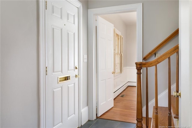103 Stedman St, Fayetteville, NC 28305 - hall featuring a baseboard heating unit, stairs, and dark tile patterned floors