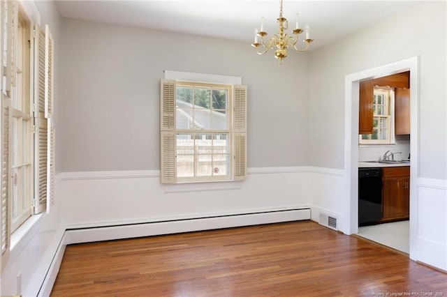 103 Stedman St, Fayetteville, NC 28305 - unfurnished dining area with a chandelier, baseboard heating, and wood finished floors
