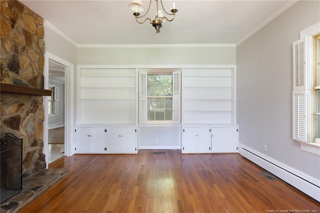 103 Stedman St, Fayetteville, NC 28305 - unfurnished dining area with baseboard heating, a chandelier, wood finished floors, built in features, and ornamental molding