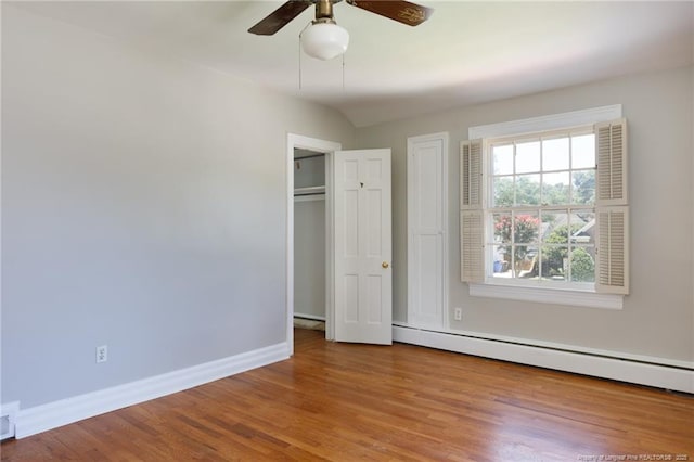 103 Stedman St, Fayetteville, NC 28305 - unfurnished bedroom with a baseboard heating unit, wood finished floors, and a ceiling fan