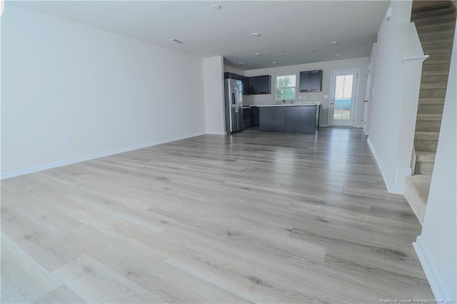 96 Cutty Way, Lillington, NC 27546 - unfurnished living room featuring stairs and light wood-style floors
