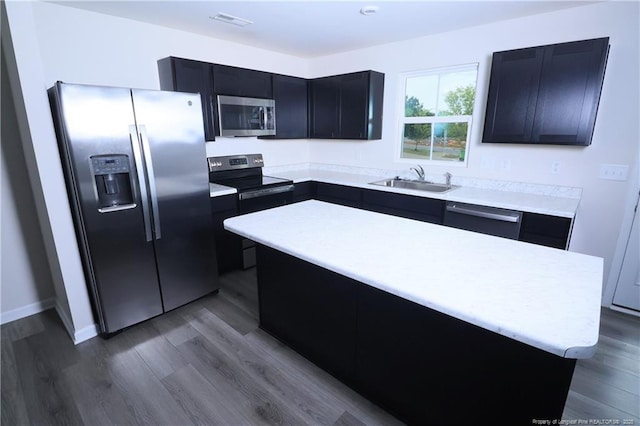 96 Cutty Way, Lillington, NC 27546 - kitchen featuring appliances with stainless steel finishes, light countertops, dark wood-style floors, and dark cabinets