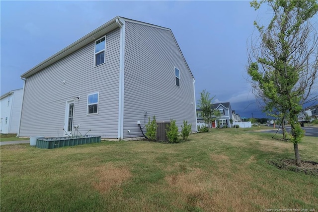 96 Cutty Way, Lillington, NC 27546 - view of property exterior with a lawn and a central air condition unit