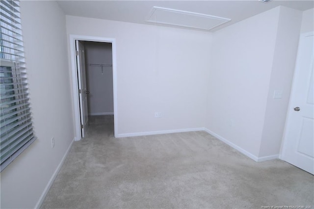 96 Cutty Way, Lillington, NC 27546 - unfurnished bedroom with attic access, carpet, a spacious closet, and a closet
