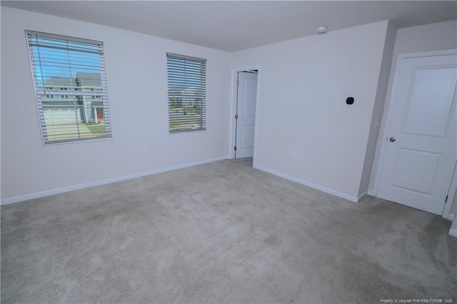 96 Cutty Way, Lillington, NC 27546 - carpeted empty room featuring baseboards and a smoke detector