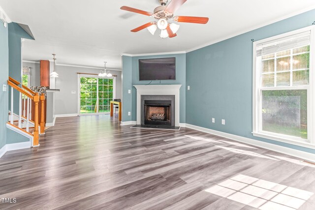 2555 Winding Creek Ln, Franklinton, NC 27525 - unfurnished living room featuring wood finished floors, ornamental molding, a fireplace with flush hearth, stairs, and ceiling fan