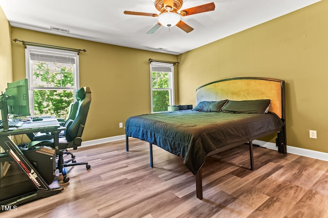 2555 Winding Creek Ln, Franklinton, NC 27525 - bedroom featuring wood finished floors, a ceiling fan, and an office area