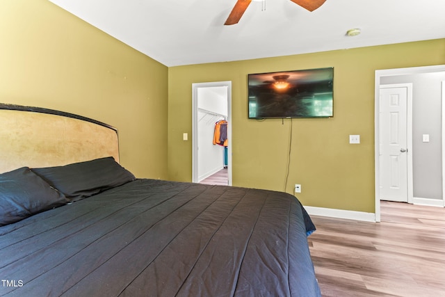 2555 Winding Creek Ln, Franklinton, NC 27525 - bedroom featuring light wood-style floors, a walk in closet, a ceiling fan, and a closet
