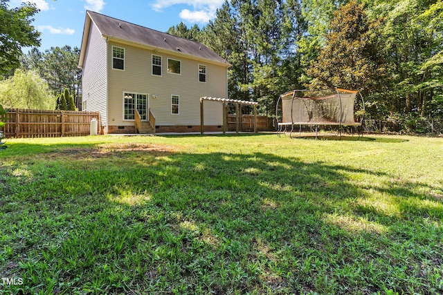 2555 Winding Creek Ln, Franklinton, NC 27525 - rear view of house featuring crawl space, entry steps, a trampoline, and a fenced backyard