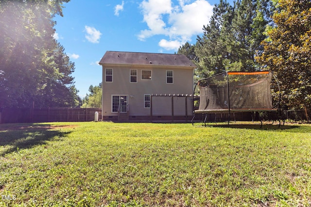 2555 Winding Creek Ln, Franklinton, NC 27525 - back of property featuring crawl space, a trampoline, and a fenced backyard