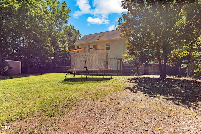 2555 Winding Creek Ln, Franklinton, NC 27525 - fenced backyard featuring a trampoline and a storage unit