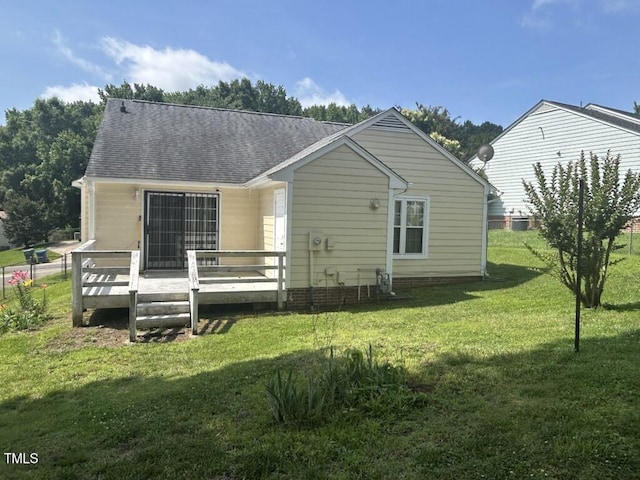 1819 Collier Rd, Durham, NC 27707 - back of property featuring a deck, a yard, and a shingled roof