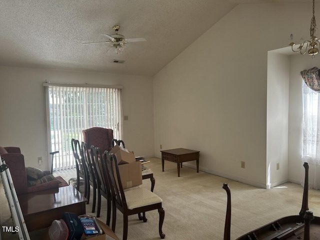 1819 Collier Rd, Durham, NC 27707 - living room featuring light carpet, plenty of natural light, vaulted ceiling, a ceiling fan, and a chandelier