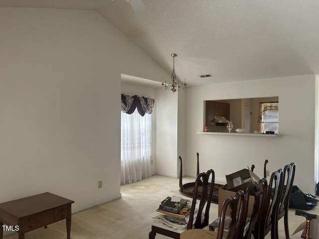 1819 Collier Rd, Durham, NC 27707 - dining area featuring light colored carpet, vaulted ceiling, and a chandelier