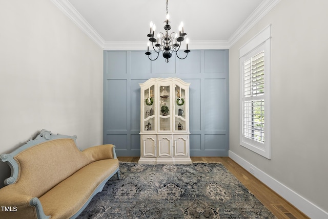 175 Stonecrest Way, Pittsboro, NC 27312 - sitting room with a chandelier, ornamental molding, wood finished floors, and a decorative wall