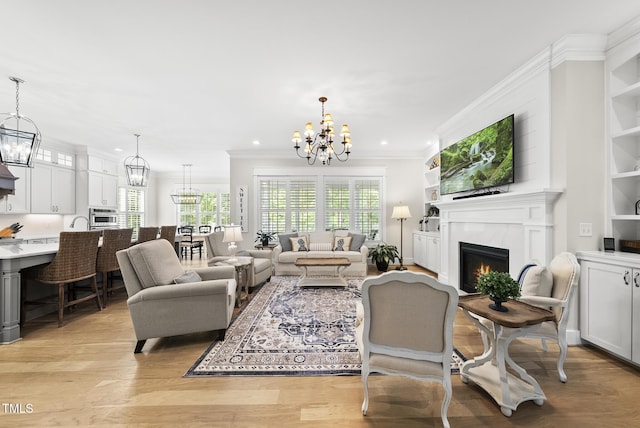 175 Stonecrest Way, Pittsboro, NC 27312 - living room with a chandelier, crown molding, plenty of natural light, light wood-style flooring, and a premium fireplace