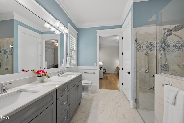 175 Stonecrest Way, Pittsboro, NC 27312 - bathroom featuring double vanity, a shower stall, crown molding, marble look tiles, and a wainscoted wall