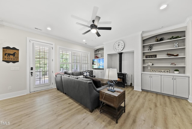 175 Stonecrest Way, Pittsboro, NC 27312 - living area with a wood stove, light wood-type flooring, ornamental molding, a ceiling fan, and built in features