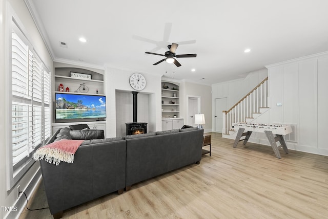 175 Stonecrest Way, Pittsboro, NC 27312 - living area featuring stairs, wood finished floors, ceiling fan, built in shelves, and crown molding