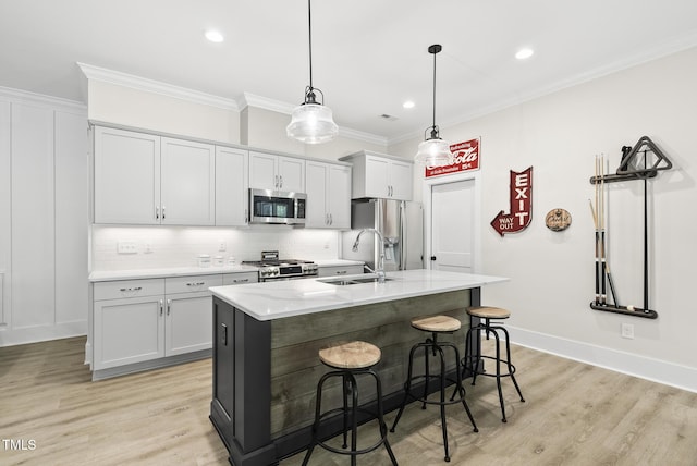 175 Stonecrest Way, Pittsboro, NC 27312 - kitchen with stainless steel appliances, a kitchen island with sink, ornamental molding, backsplash, and a kitchen bar