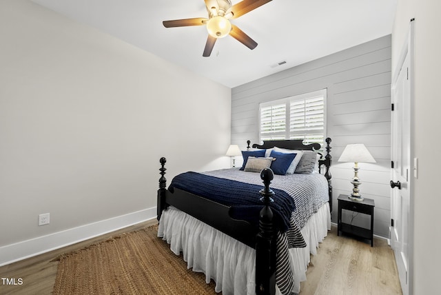 175 Stonecrest Way, Pittsboro, NC 27312 - bedroom featuring light wood-style floors, wooden walls, and a ceiling fan