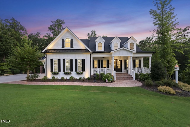 175 Stonecrest Way, Pittsboro, NC 27312 - view of front of home featuring covered porch, a front yard, board and batten siding, a standing seam roof, and french doors