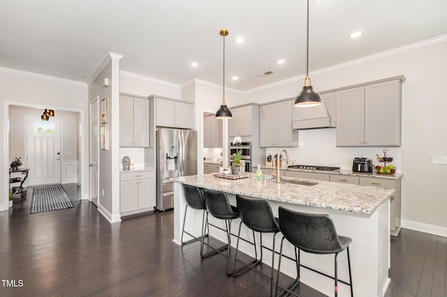 664 Old Dairy Dr, Wake Forest, NC 27587 - kitchen with appliances with stainless steel finishes, gray cabinets, dark wood finished floors, a breakfast bar area, and a center island with sink