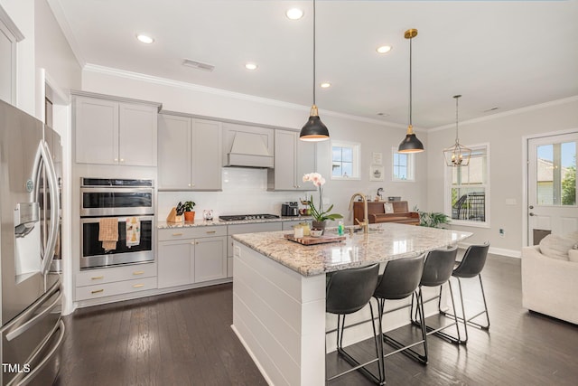 664 Old Dairy Dr, Wake Forest, NC 27587 - kitchen featuring appliances with stainless steel finishes, premium range hood, plenty of natural light, dark wood-type flooring, and ornamental molding