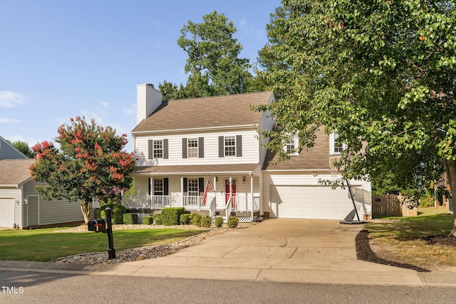 4316 Major Loring Way, Raleigh, NC 27616 - view of front of home featuring covered porch, concrete driveway, a garage, a chimney, and a front yard