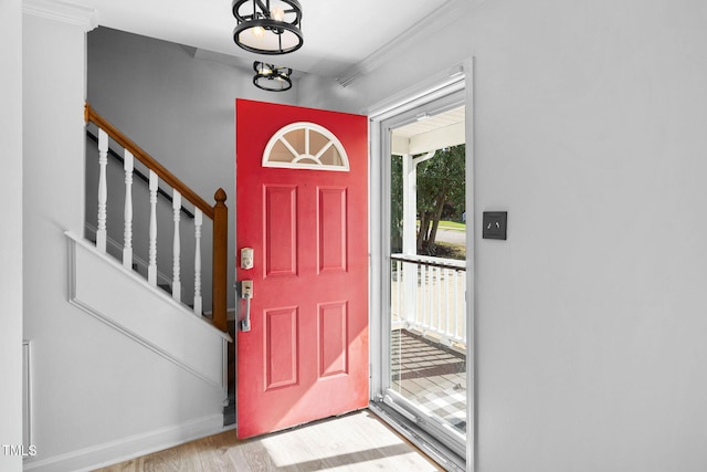 4316 Major Loring Way, Raleigh, NC 27616 - entrance foyer featuring wood finished floors, crown molding, stairway, and a chandelier