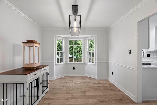 4316 Major Loring Way, Raleigh, NC 27616 - unfurnished dining area featuring light wood-style floors and ornamental molding