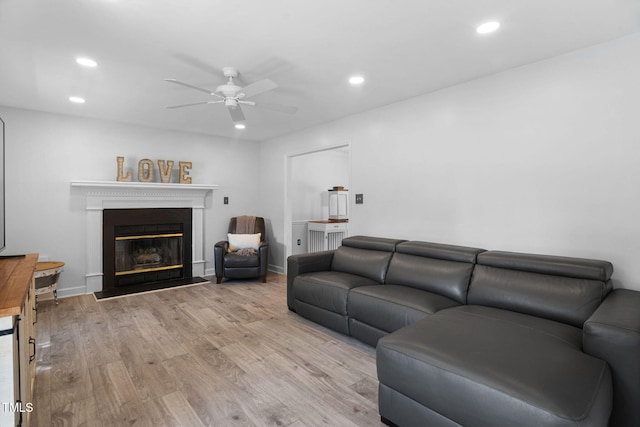 4316 Major Loring Way, Raleigh, NC 27616 - living area with light wood-style floors, ceiling fan, a glass covered fireplace, and recessed lighting