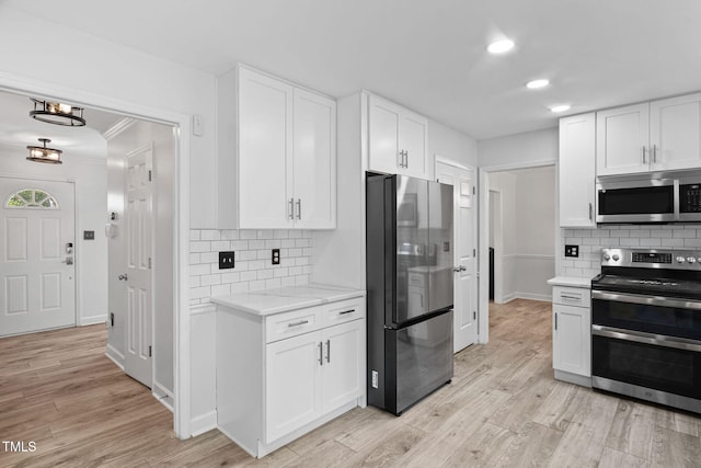 4316 Major Loring Way, Raleigh, NC 27616 - kitchen featuring appliances with stainless steel finishes, white cabinets, backsplash, light wood-type flooring, and recessed lighting