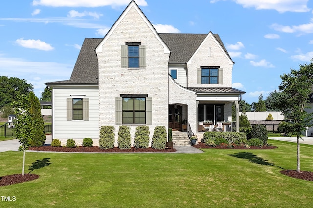 241 Teague St, Wake Forest, NC 27587 - view of front of home featuring a shingled roof, a standing seam roof, and covered porch