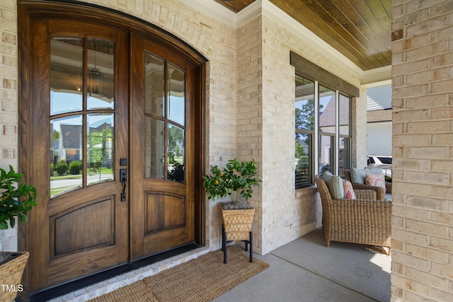 241 Teague St, Wake Forest, NC 27587 - property entrance featuring covered porch, brick siding, and french doors